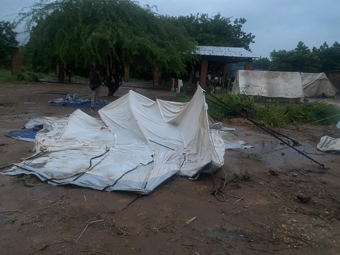 Evacuation Tents are being blown away by after winds of Cyclone Freddy - Families congregate in shelter at back. 